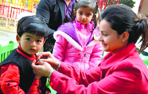 A mother readies her son for a baby show at Saraswati Modren School in Ludhiana on Friday.