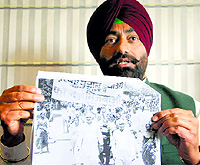 Congress spokesman Sukhpal Khaira shows the photograph of LK Advani leading "Rosh march" in May 1984, in Amritsar on Friday