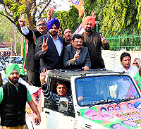 BJP state president Kamal Sharma, SAD nominee Manpreet Singh Ayali and other leaders during a car rally in Ludhiana on Friday