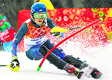 Mikaela Shiffrin of the US clears a gate during the first run of the women's alpine skiing slalom event at the 2014 Sochi Olympics
