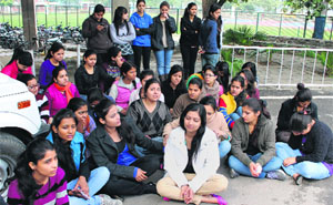 Students of Shri Dhanwantry Ayurvedic College sit on a dharna outside the Syndicate meeting hall at Panjab University on Saturday.