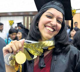 A student shows her medals after the sixth convocation of the National Law Institute University in Bhopal on Saturday