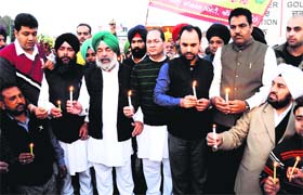Paying tributes: Congress leaders take out a candlelight march to pay tribute to the farmer who lost his life during a protest in Amritsar