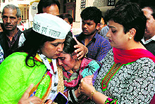 Aam Aadmi Party workers console the mother of the deceased, Ashima Sharma, at Mansa Devi Complex in Panchkula on Sunday