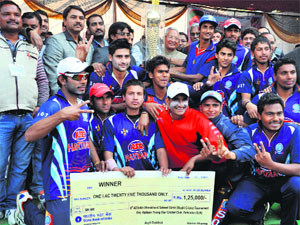 Members of the Haryana XI team after winning the Girish Bhadri Cricket Tournament at Rangers Ground in Dehradun on Sunday. 