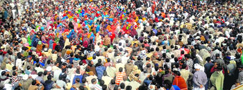 People sit on a dharna with murdered BJP leader Rakesh Malik's body in Tosham on Sunday.