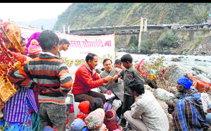 A medical team examines migrant labourers in Chamba