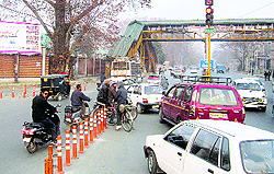 Motorists jump the red signal at an intersection in Srinagar on Sunday