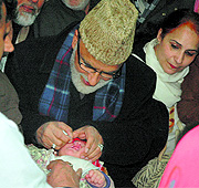 Minister for Rural Development Ali Mohammad Sagar administers polio drops to a child at Jawaharlal Nehru Memorial Hospital, Rainawari, on Sunday