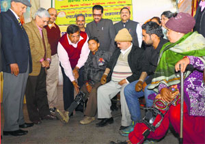 Physically challenged persons receive artificial limbs at a camp in Ludhiana on Sunday. 
