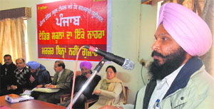 A member of the Punjab Aided School Teachers and Employees Union speaks at a meeting in Ludhiana on Sunday.