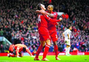 Liverpool's Jordan Henderson celebrates his second goal against Swansea with Glen Johnson (R) during their English Premier League soccer match at Anfield. 