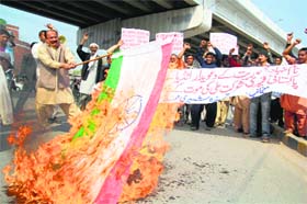 Pakistan protesters burn the Indian flag during a protest against the death of a Pakistani prisoner in Indian jail, at a rally in Multan on Sunday