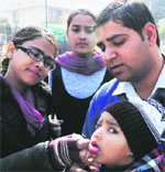 Health officials administer polio drops to a child during a door-to-door campaign in Amritsar on Monday. Photo: Vishal Kumar