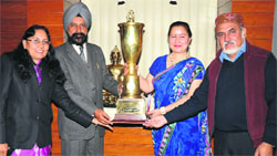 Dr Jagjit Kaur hands over the national youth festival trophy to Vice-Chancellor AS Brar during a function on GNDU premises in Amritsar on Monday. A Tribune photograph