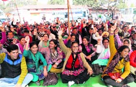 Members of the Uttarakhand Shiksha Mitra Mahasangh stage a protest in Dehradun on Monday