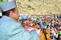 Forest Minister TS Bharmouri addresses a public meeting at Dharwala in Chamba on Monday.