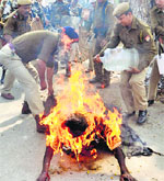 The police try to save a protester in Guwahati on Monday. AFP photo