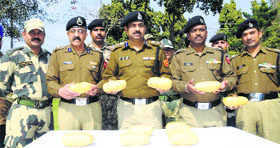 MF Farooqui, DIG (centre), and other officers with the seized heroin at Khasa village near Amritsar on Monday.