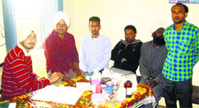 Avtar Singh (left), a pharmacist, attends patients in the absence of a doctor in the dispensary at Dhalleke village in Moga district.