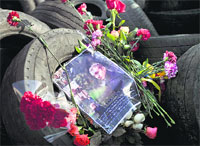 Flowers and a portrait of a killed anti-government protester lies on a barricade in central Kiev on Monday. AFP