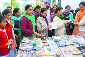 Principal Mandeep Kaur, along with the staff members and students, looks at books at the two-day fair that began in Amritsar on Tuesday.