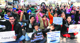Computer teachers protest outside the office of the DPI in support of their demands in Chandigarh on Tuesday.