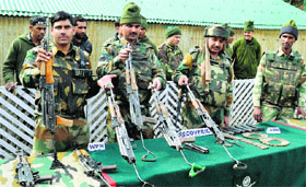 Army men display arms and ammunition seized from the militants killed in Kupwara on Monday.