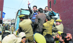 The police detain members of the Jammu and Kashmir Contractors Coordination Committee during a protest in Srinagar on Tuesday.