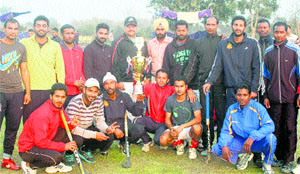 Players of the Amrit Sports Club in a jubilant mood after winning Sansarpur Hockey Cup in Jalandhar Cantonment on Tuesday.