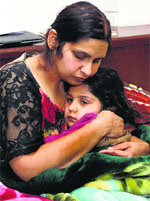 Navneet Kaur hugs her daughter Diya in Jalandhar on Tuesday.