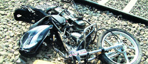 The mangled remains of the motorcycle which the youths were riding.
