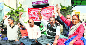 Members of the Non-Teaching Employees Union stage a protest at Arya College in Ludhiana on Tuesday.