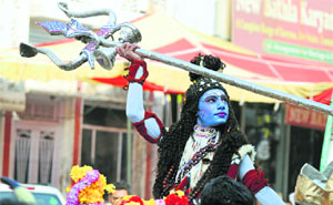 A devotee dressed as Lord Shiva during a shobha yatra taken ahead of Shivratri in Ludhiana on Tuesday.