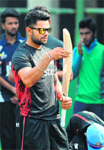 Indian captain Virat Kohli checks a bat during a training session at the Sher-e-Bangla National Cricket Stadium in Dhaka
