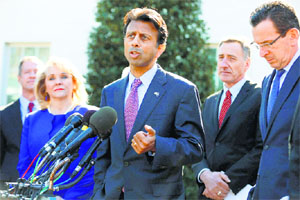Louisiana Governor Bobby Jindal (C) speaks to reporters outside the White House in Washington