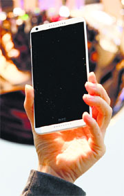 A model displays HTC Desire smartphone at the Mobile World Congress in Barcelona on Wednesday
