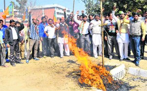 BJP workers burn an effigy of MP Pawan Kumar Bansal in Chandigarh on Wednesday. 