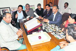 Congress councillors discuss about the deplorable condition of roads with Mayor Vinod Chamoli at his office in Dehradun on Wednesday. A Tribune photograph