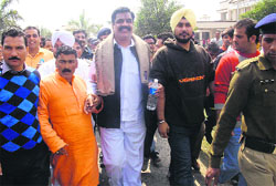 BJP MLA Rajkumar on his way to surrender in a court at Rudrapur on Wednesday. A Tribune photograph