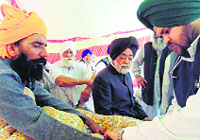 A doctor examines Jarnail Singh Brar (left) in Sirsa on Wednesday. A Tribune photograph