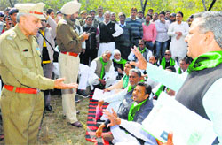 Suspended INLD legislators protest outside the Haryana Vidhan Sabha in Chandigarh on Wednesday as police officials look on. Tribune photo: Manoj Mahajan