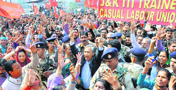 Members of the Centre of Indian Trade Union stage a protest in Jammu on Wednesday.