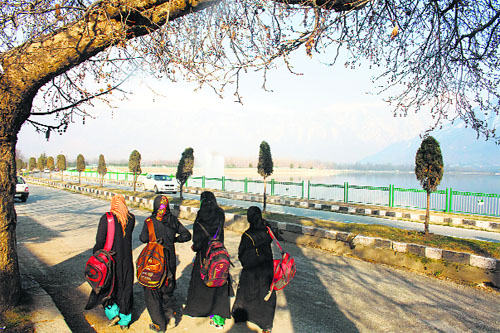 A walk to remember : Students enjoy a stroll on the banks of the Dal Lake in Srinagar.