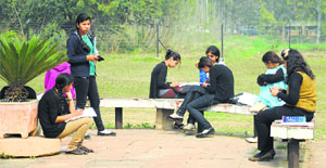 Students come out of classrooms to enjoy a sunny day at PAU in Ludhiana on Wednesday.