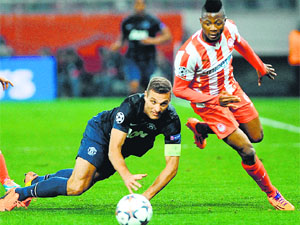 Manchester United's Serbian defender Nemanja Vidic (L) vies with Olympiakos's Nigerian forward Michael Olaitan during the round of 16 Champions League match in Athens on Monday. 