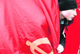 A young activist wraps himself in a Soviet-era communist flag, as pro-Russian activists take part in a rally in front of the Lenin monument in the Ukrainian city of Donetsk on Wednesday