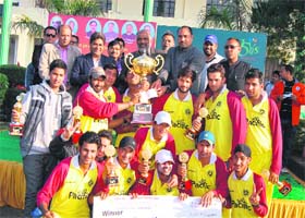 Team members of Himalayan Cricket Academy pose with their trophy at Glocal School in Dehradun on Thursday