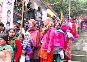 Foreigners in queue among the devotees at the Tapkeshwar temple during Mahashivratri on Thursday