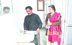 Patients attendants fill water bottles from a washroom in Civil Hospital, Jalandhar. 